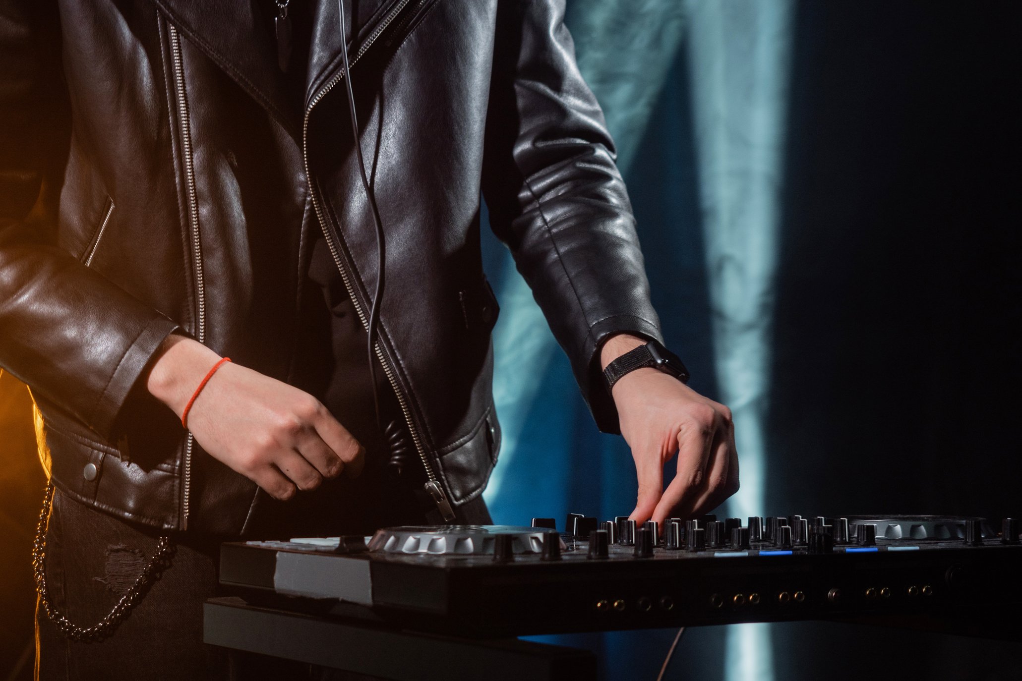 Person in Black Leather Jacket Playing Black and White Electric Keyboard